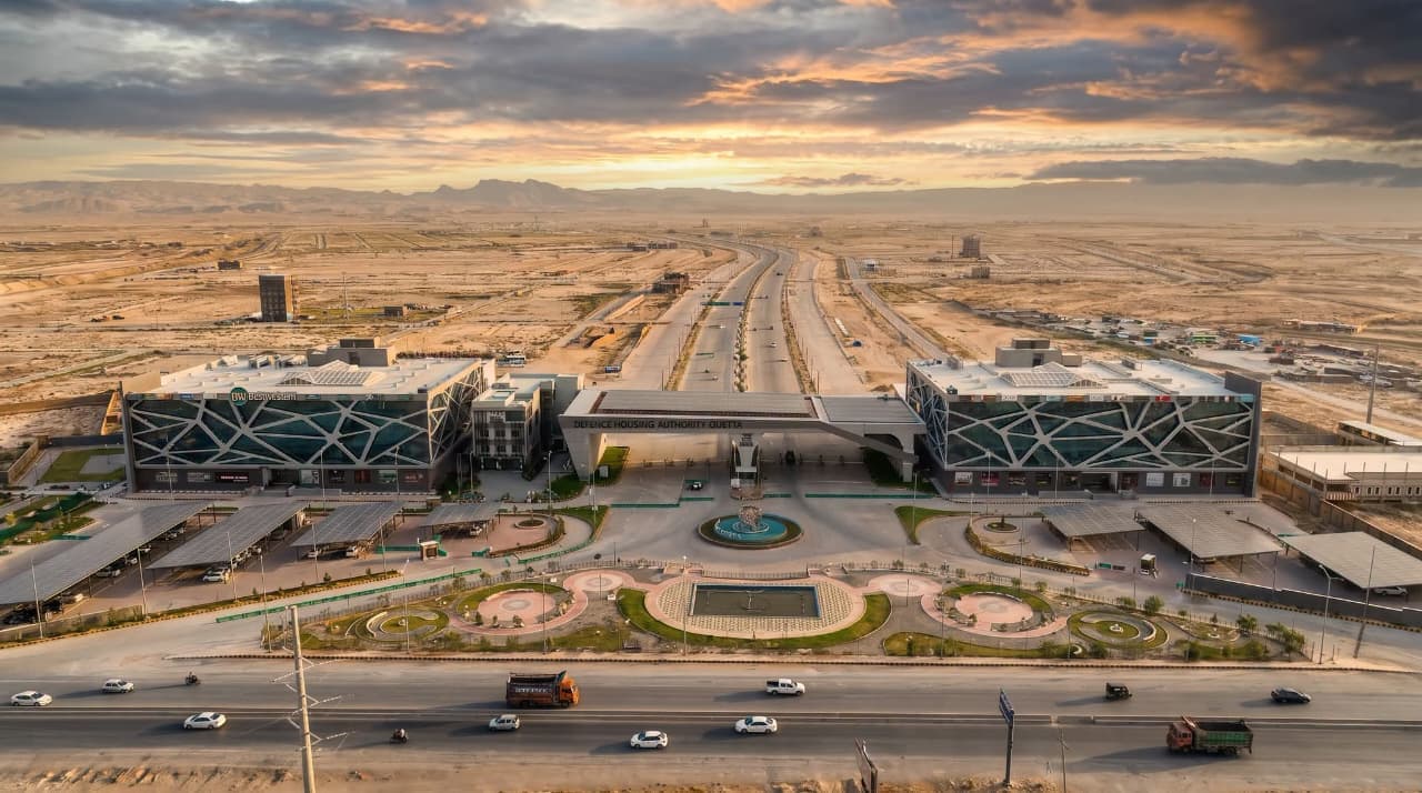 The Defence Housing Authority Quetta gateway and its two commercial buildings seen from the air at sunset